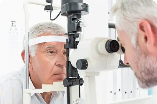 Hindsight eye care professional performing a retinoscopy test on a senior patient to assess vision clarity.
